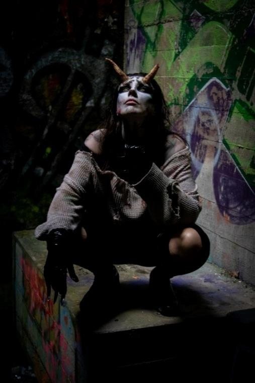 Horned fantasy creature amid graffiti